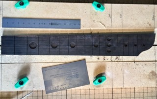 CNC'd fretboard with moon inlays and alien heads